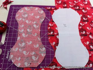 Flannel burp cloths being cut out of pink bird fabric.