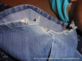 Hemming jeans with a ripped seam.