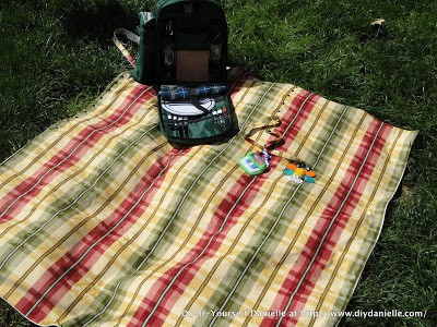 Completed DIY picnic blanket with picnic backpack on top.