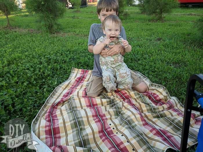 DIY Picnic blanket with two of my sons sitting on it.