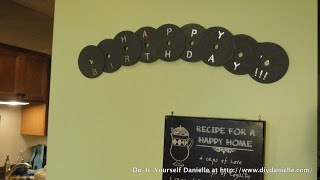 "Happy birthday" banner made from compact discs. Gray.