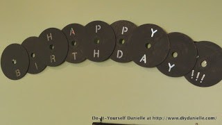 Gray happy birthday banner with CDs