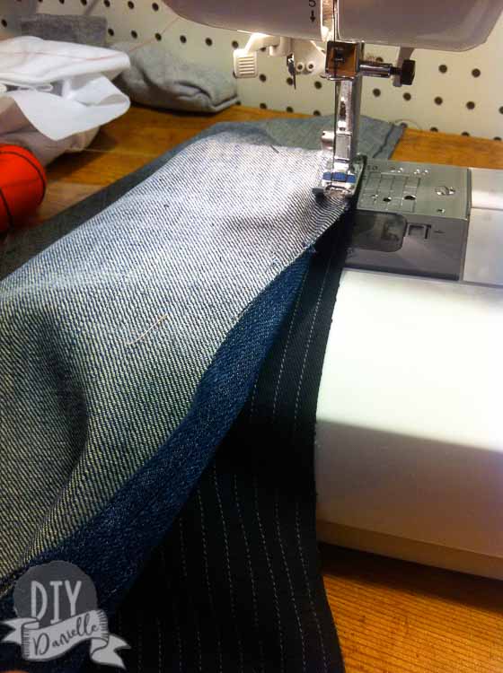 Sewing strips of jeans right sides together.