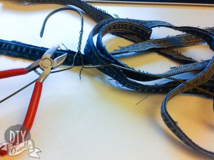 Supplies for a denim bracelet: upcycled jeans, wire.