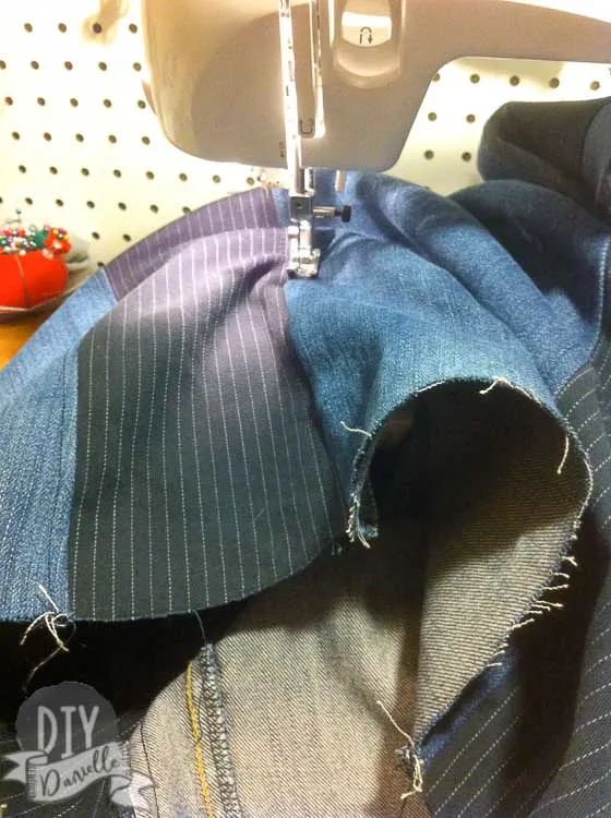 Top stitching the strips of jean fabric.