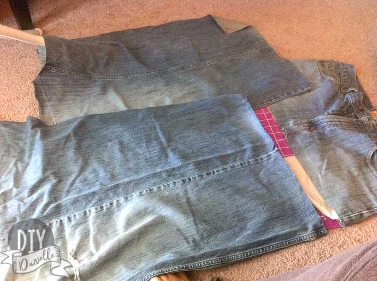 Cutting apart jeans to upcycle into a patchwork skirt.