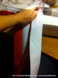 Sewing white and red stripes together for the hat.