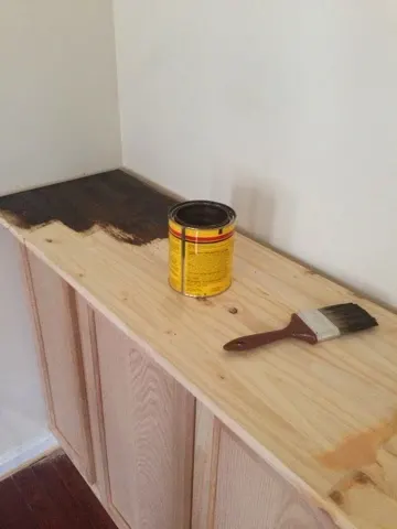 Staining the wood countertop.