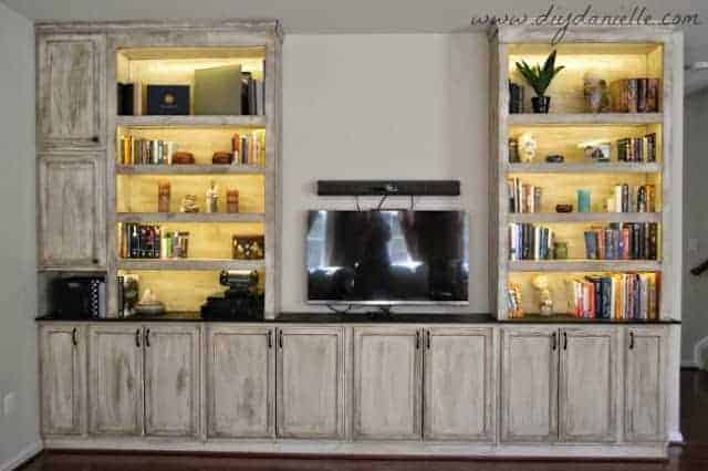 Built In bookshelves, storage, and entertainment center: lights on.