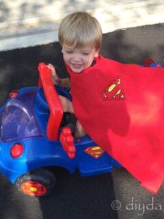 How to make a superhero cape without sewing. This is a no sew children's cape worn and a coordinating Superman car.