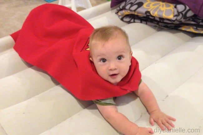 Baby wearing a no sew superhero cape: learn how to make this cape without sewing.