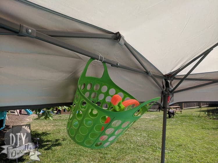 Hanging toy storage from the canopy over the pool.