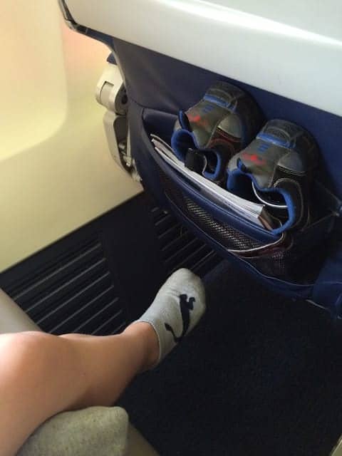 Shoes stored for the flight so the kids can't kick as hard if they bump the seat in front of them.