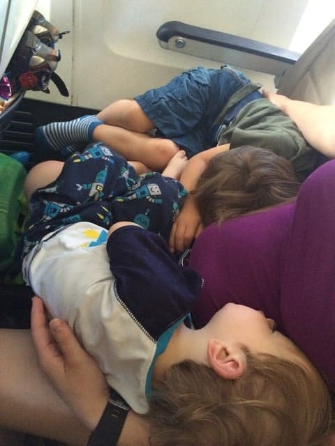 When traveling with kids, choosing a good flight time is important for a peaceful trip. Kids sleeping on a late flight.