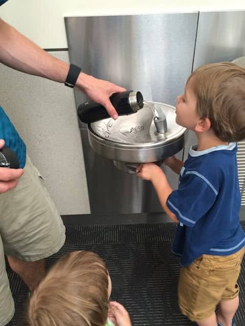 Refilling water bottles for a flight. Make sure to get a water bottle that won't build up pressure inside on the flight.