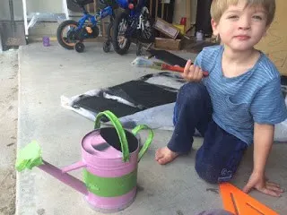 Painting an upcycled watering can.