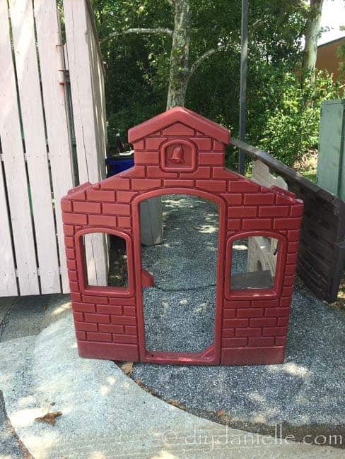 Plastic playhouse by dumpster at the gym,