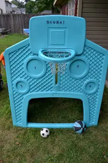 Basketball hoop and soccer goal on a plastic playhouse.