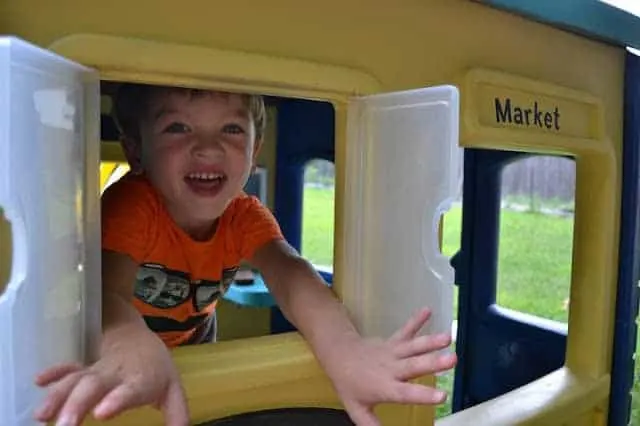 Windows in a painted plastic playhouse.
