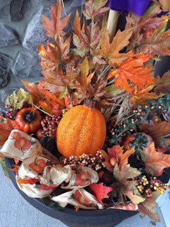 I added a wreath, then a pumpkin and my scarecrow to this old planter.