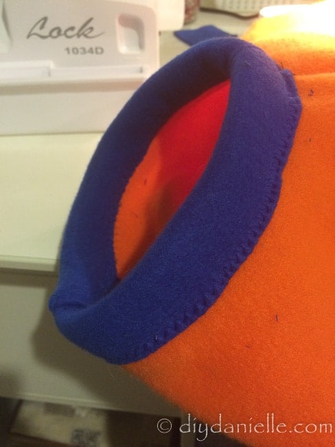 Finished blue neckband on the orange vest.