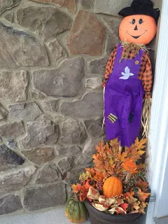 Scarecrow and wreath setup with an old planter for my Fall front porch. 