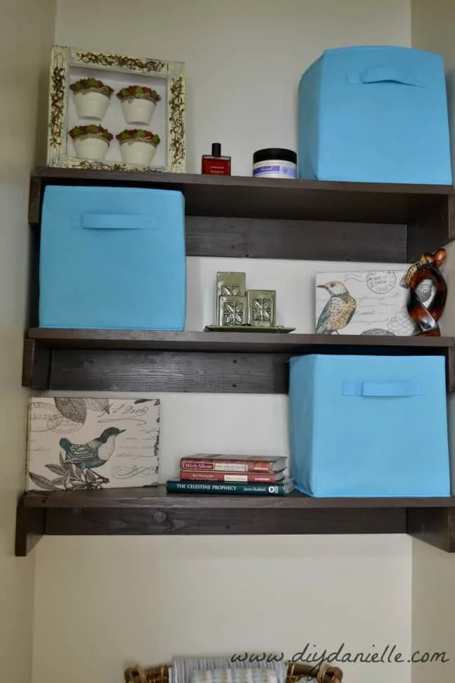 Close up of our small bathroom shelving and decor.