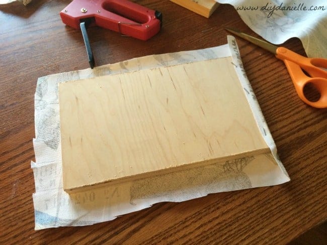 Lay your wood on the fabric and center.