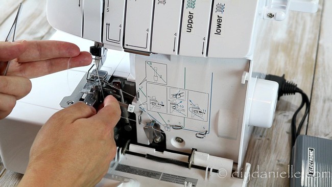 Threading the lower looper- pull the white tab piece out.