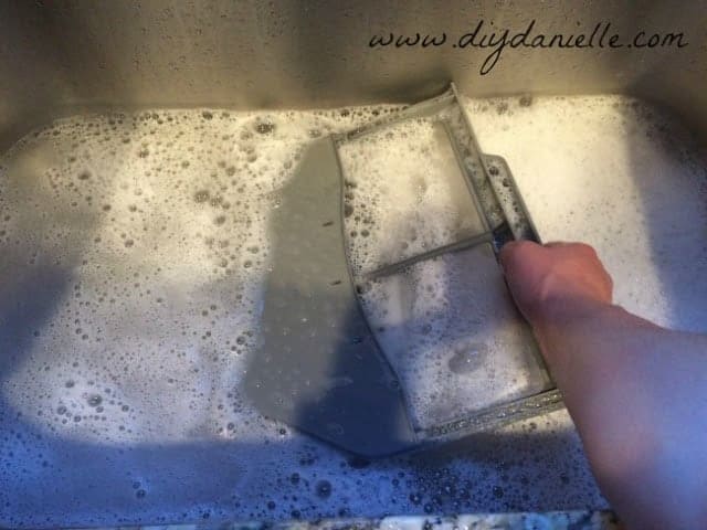 Wash the lint trap in hot soapy water.