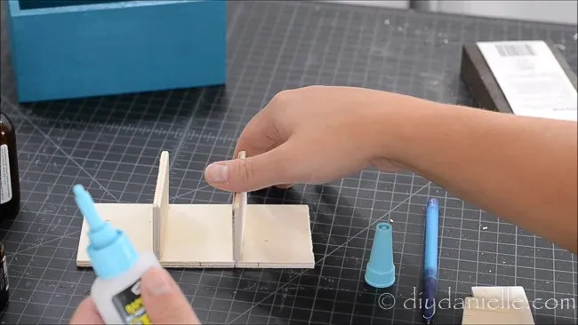 Use glue to hold the pieces of wood in place. Let dry.