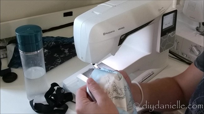 Sew a straight stitch with the right sides of the fabric together. This creates a corner for the fitted cover.