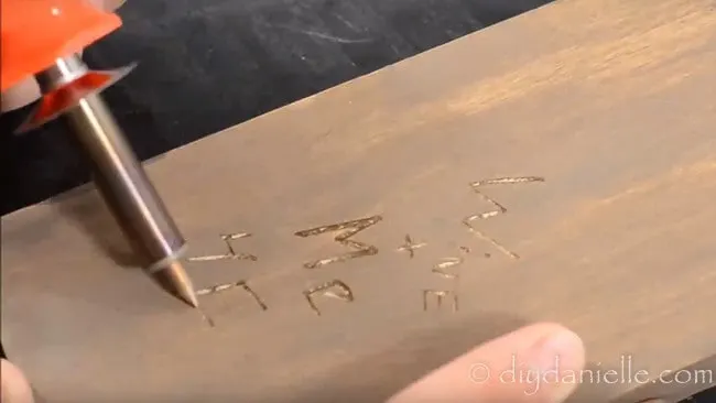 Use a carving knife to carve 'Wine + Me 4Eva' then fill in with a wood burning tool.