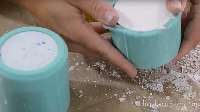 Dried concrete planters being removed from a silicone mold