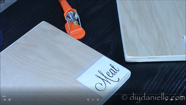 Tracing words onto cutting board to burn.