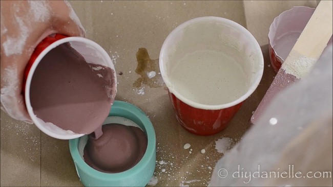 Adding pink concrete mix for a DIY candle holder.