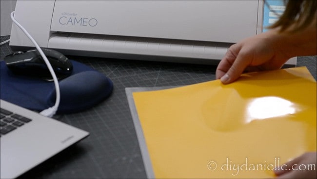 Putting 631 vinyl on a cutting mat for the Silhouette machine.