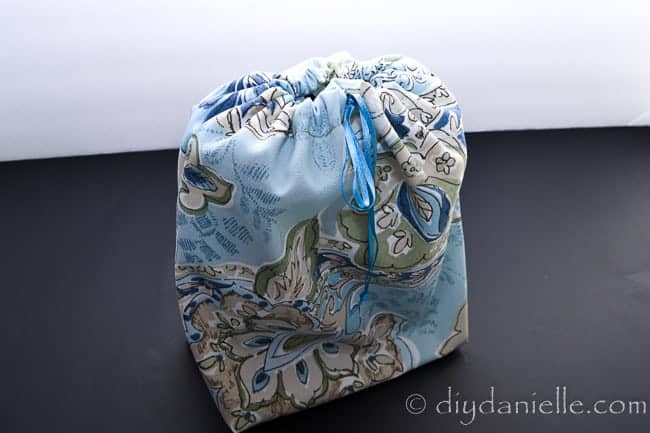 Fabric gift bag with a drawstring.