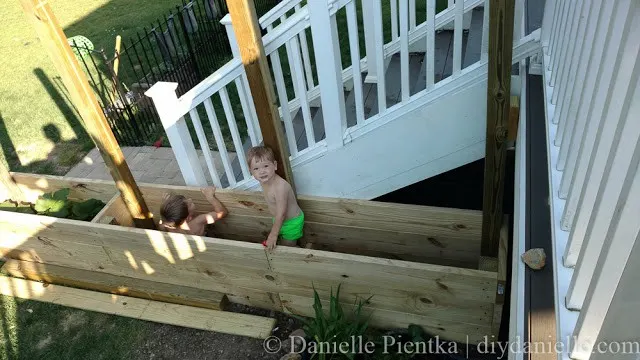Kids playing in the deep privacy planters.