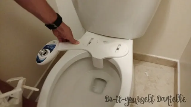 Bidet sprayer attachment on the toilet.