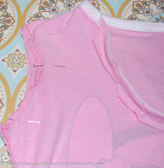 Sewing arm holes and bottom of shirt closed to make a tshirt clothespin bag.