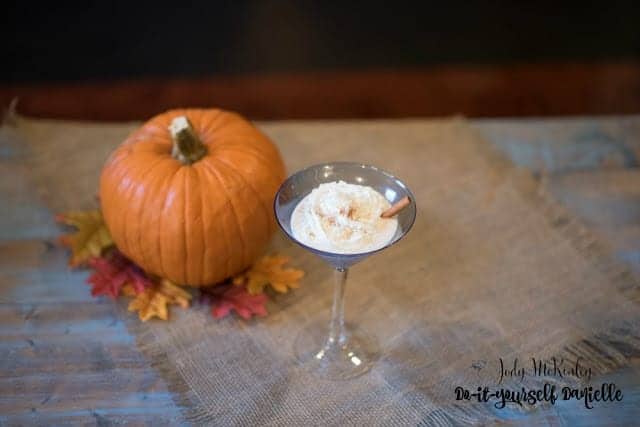 Pumpkin spice chata cocktail in a blue martini glass.