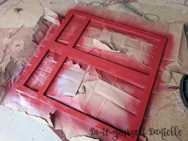 Spray painting the cabinet front red.