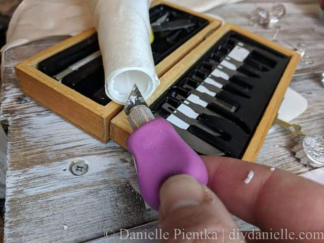 Carving the inside of an upcycled serger cone to make the bulb fit.