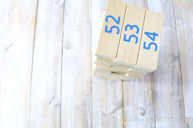 DIY Questions Jenga Game setup with the numbers showing. The numbers were cut with my Cricut machine and in Blue permanent vinyl. 