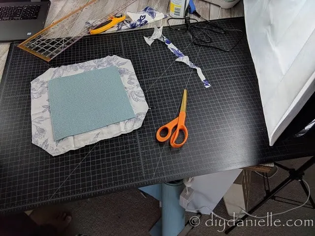 Cutting fabric and a yoga mat to make a mousepad.