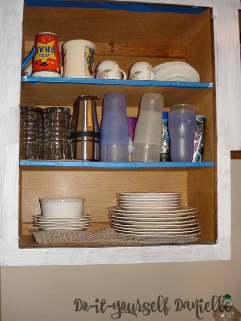 Taped and primed kitchen cabinets.