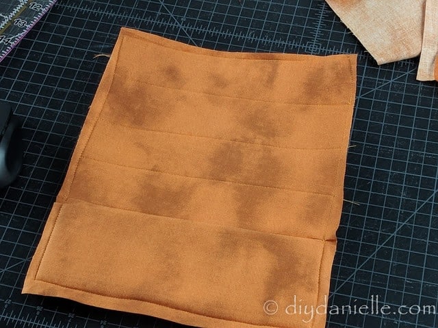 Sew your fabric to your mouse pad, then trim excess fabric.