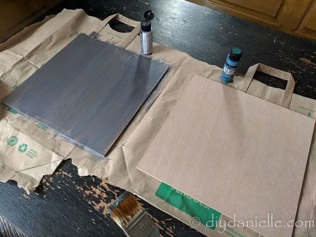 Painting 12x12 art boards for nursery decor signs.