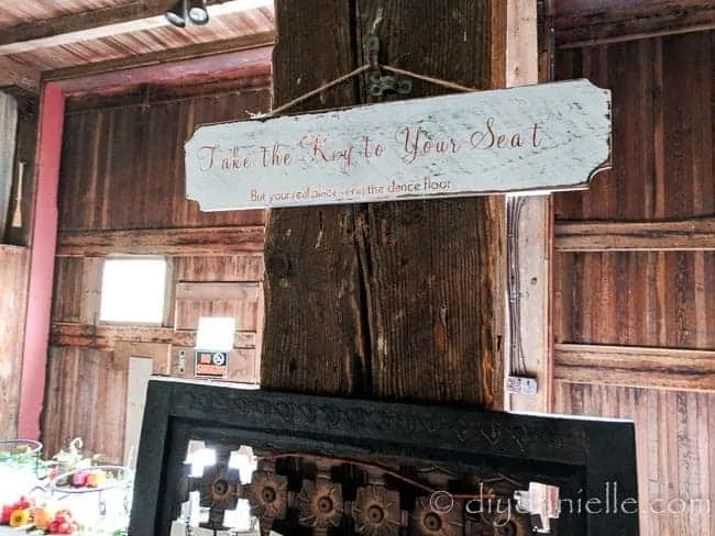 "Take the key to your seat: But your real place is on the dance floor" sign for a wedding reception. Made with a Cricut cutting machine.